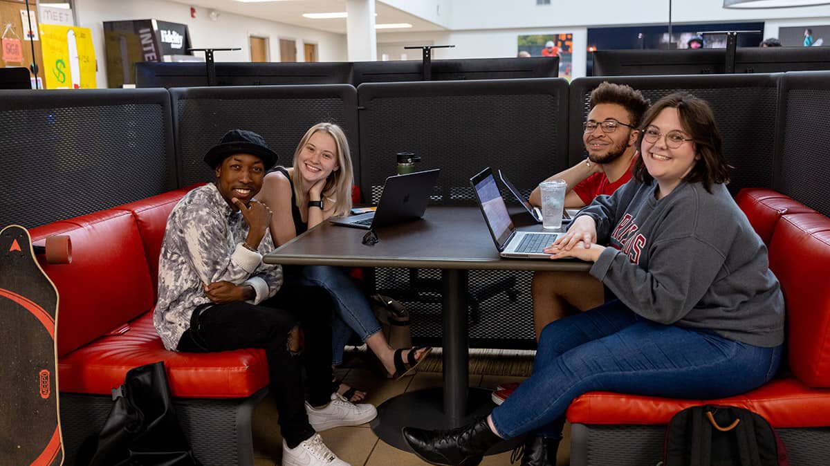 Students sitting in booth